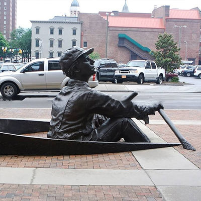 People Rowing Boats Bronze Statues Sculpture On Streets Of Park Square