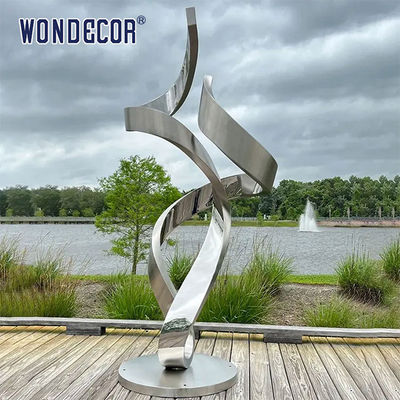 Large forged metal shaped twisted geometric stainless steel sculpture in the park